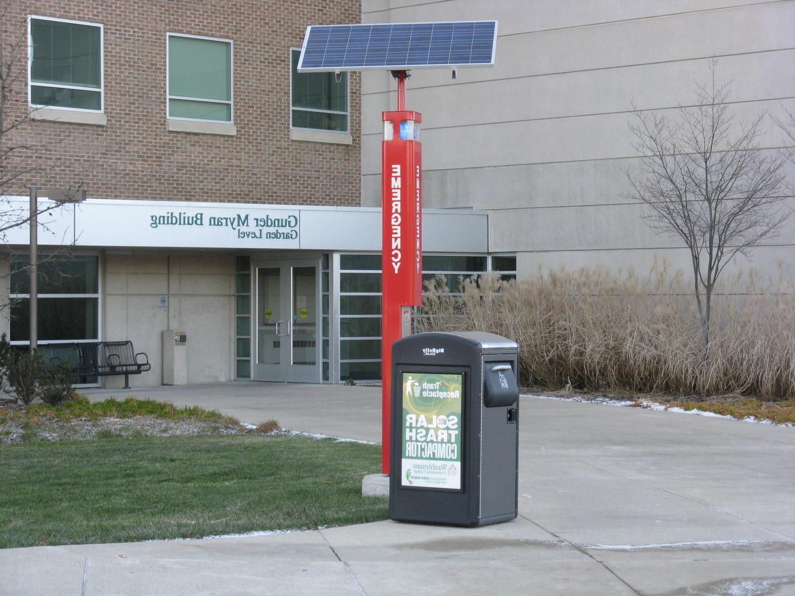 Solar powered emergency phone and trash compactor